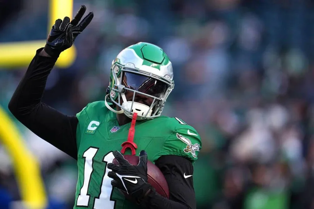 A.J. Brown of the Philadelphia Eagles holds up two fingers with his right hand while carrying a football in his left hand.